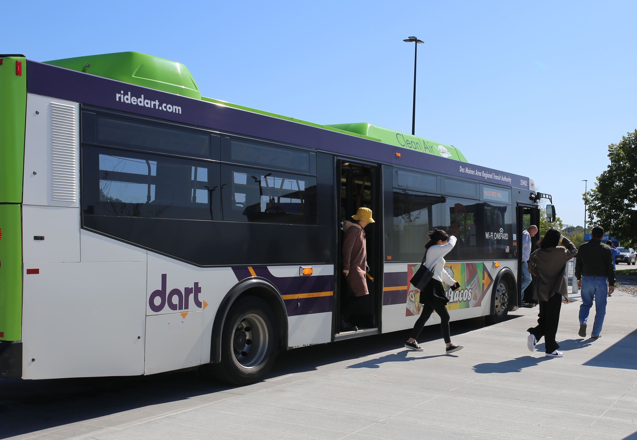 passengers exit a DART bus